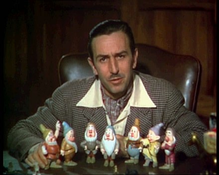 A 1937 image of Walt Disney (with figurines of the Seven Dwarfs) in his office at the former Hyperion studio. The office later became part of the Shorts Building on the Burbank lot
