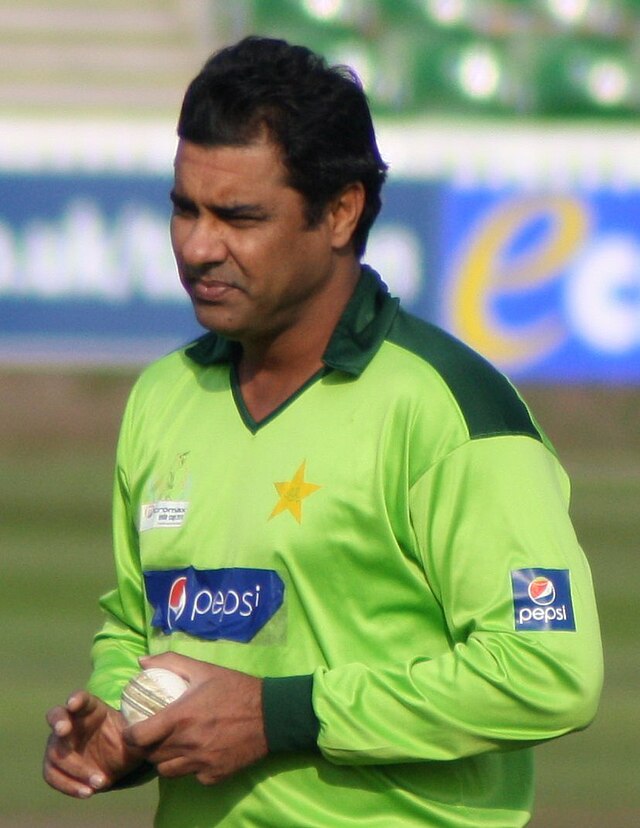 A man wearing Pakistani national cricket team ODI uniform with a cricket ball in his left hand, prepares to bowl during a net.