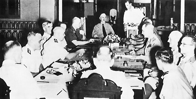 The first ABDACOM conference. Seated around the table, from left: Admirals Layton, Helfrich, and Hart, General ter Poorten, Colonel Kengen (at head of