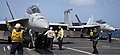 A U.S. Navy aviation boatswain's mate, far left, directs an F-A-18E Super Hornet aircraft assigned to Strike Fighter Squadron (VFA) 154 on the flight deck aboard the aircraft carrier USS Nimitz (CVN 68) in 130408-N-SK881-135.jpg