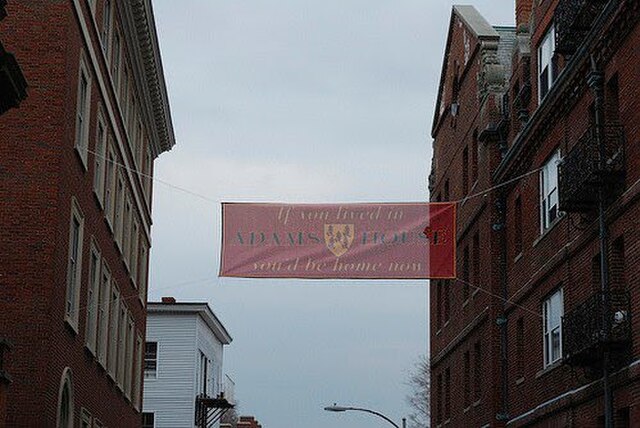 A sign above the main entrance to Adams House at 26 Plympton St, commemorating the annual college Housing Day for freshman. It reads, "If you lived in
