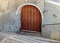 Old wooden door of a House on Plaz in Vnà.