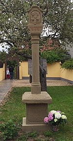 Original side portals, today in the parish garden (left) and in the inner courtyard by the church (right, in the background)