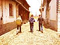 Three boys walk through the streets of Xizhou.