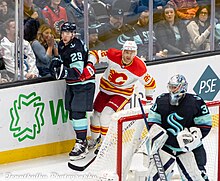 Trevor Lewis (center) during a game against the Seattle Kraken in December 2022. Calgary Flames at Seattle Kraken - December 28, 2022 - dunn 12 28-3 (52596002876).jpg