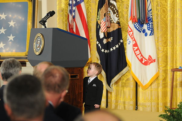 In advance of February 11, 2013 Medal of Honor ceremony in the East Room of the White House, Clinton Romesha's son, Colin, inspects the lectern that w