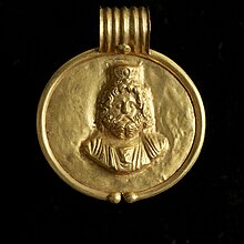 This pendant bearing Serapis's likeness would have been worn by a member of elite Egyptian society. Walters Art Museum, Baltimore. Egyptian - Pendant with Image of Sarapis - Walters 571524 - Front View B.jpg