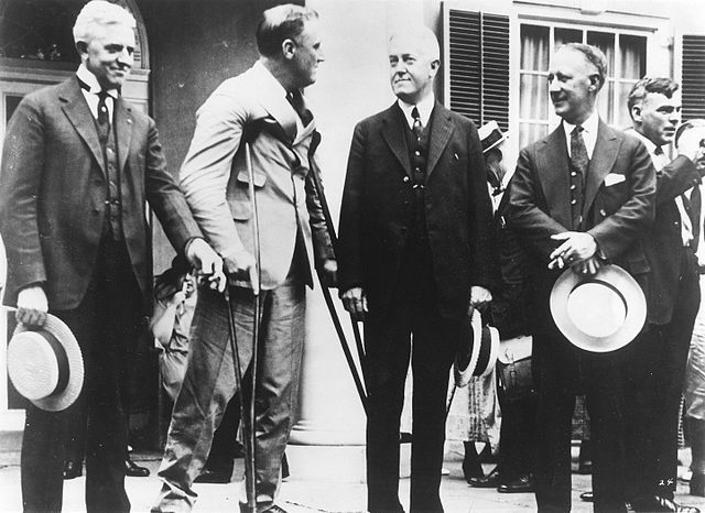 Roosevelt supporting himself on crutches at Springwood in Hyde Park, New York, with visitors including Al Smith (1924)