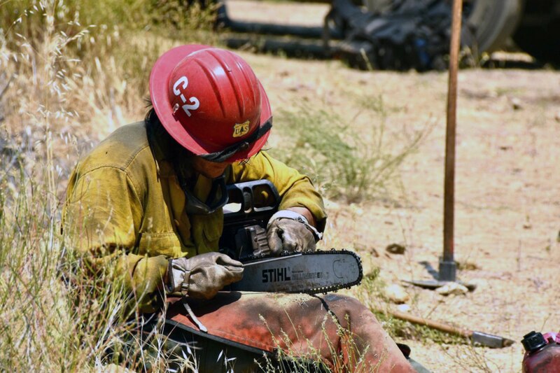 File:Firefighter Maintaining Chainsaw Willow Fire 2021.jpg