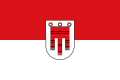 Red-white with coat of arms of the counts of Montfort. Flag of the state of Vorarlberg.