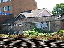 The former Kinemacolor studios in Hove, used for narrative films by the Natural Color Kinematograph Company, seen in 2005. The word "KINEMACOLOR" is visible, painted to the side of the building. Former Kinemacolour film studios, Cambridge Grove, Hove - geograph.org.uk - 41920.jpg