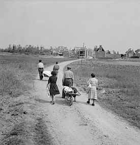 A French family returns to their village, Buron, northwest of Caen, which was completely destroyed during fighting, 18 July 1944. Frenchciviliansburon.jpg