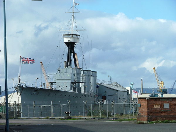 HMS Caroline sporting her three flags (From left to right) Union Jack, Commodore RNR's Broad pennant, White Ensign whilst still in commissioned servic