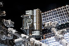 ISS-65 An iROSA in the grip of the Canadarm2 robotic arm ISS-65 An iROSA in the grip of the Canadarm2 robotic arm.jpg