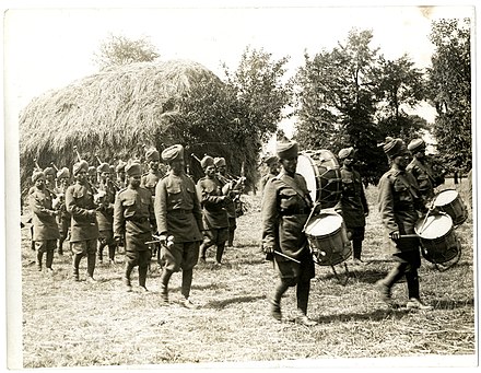 An infantry band from the 40th Pathans playing on a French farm in Saint-Floris.
