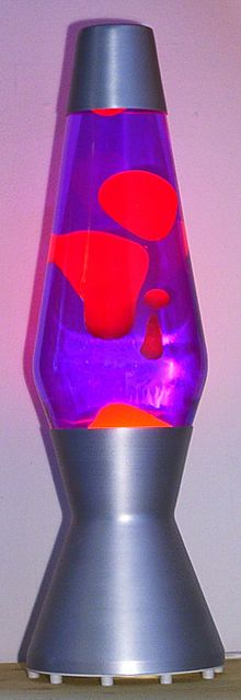 A lava lamp is a novelty item that contains wax melted from below by a bulb. The wax rises and falls in decorative, molten blobs.