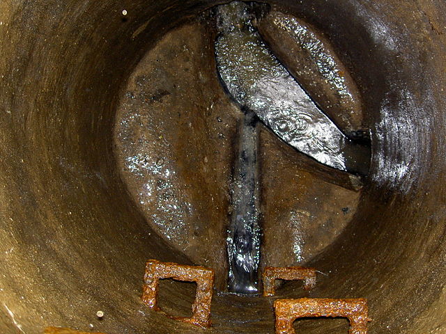 Gravity sewer flow as seen looking down into an open sanitary manhole.