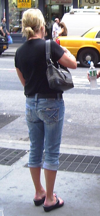 A woman wearing denim pedal pushers on Broadway in SoHo, New York City (Summer 2011)