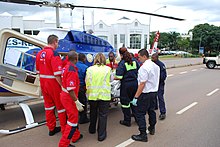 Various ambulance crews help to load a patient into an air ambulance in Pretoria Pretoria paramedics.jpg