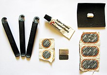 Puncture repair kit, complete with tire levers, vulcanizing fluid, abrasive grater and fabric, puncture patches, and a bit of chalk to mark the puncture Puncture-repaire-kit.jpg