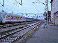International intercity train with electric traction at departure quickly gaining speed