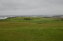 A ruined cottage, now replaced with a Portakabin, used until recently as a fisherman's shelter