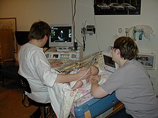 Sonographer doing pediatric echocardiography.JPG