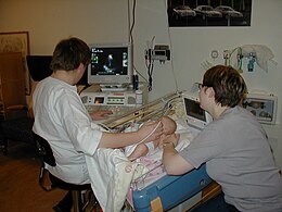 Sonographer doing pediatric echocardiography.JPG