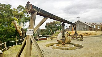 Replica horse-powered Chilean Mill at Sovereign Hill open-air museum in Ballarat. Sovereign Hill - Normanby Street - Chilean mill and church.jpg