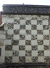 The wall of this side chapel at St Michael's Church, Mickleham is built with locally quarried flint and clunch arranged in a checkerboard pattern, in an homage to the flag of Surrey. St Michael's Church, Old London Road, Mickleham (NHLE Code 1028835) (Chequerboard Wall of Side Chapel).JPG