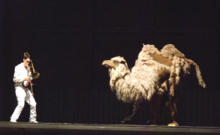 Trombonut (Stephen Menotti) and Lucicamel in the Camel Dance from Michaelion (Birmingham Opera, 24 August 2012) Stockhausen Michaelion Kameltanz 24Aug2012(1).png