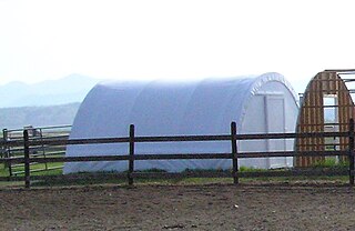 Tension fabric building Rigid framed, stretched fabric covered