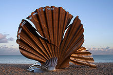 Scallop by Maggi Hambling is a sculpture dedicated to Benjamin Britten on the beach at Aldeburgh. The edge of the shell is pierced with the words "I hear those voices that will not be drowned" from Peter Grimes. (Source: Wikimedia)