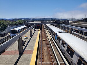 Two trains at Daly City station, July 2023.jpg