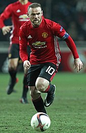 Wayne Rooney, shown wearing the number 10 jersey, was used at Manchester United as a second striker on many occasions, playing behind the number 9. Wayne Rooney 144855.jpg