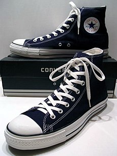 A classic Black pair of Converse All Stars resting on the Black & White Ed. Shoebox (1998-2002).JPG