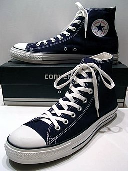 A classic Black pair of Converse All Stars resting on the Black & White Ed. Shoebox (1998-2002)