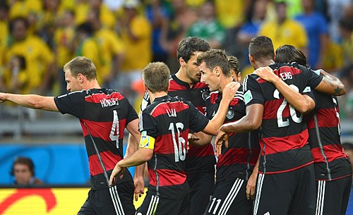 Miroslav Klose (center) celebrating with teammates after scoring the second goal for Germany.