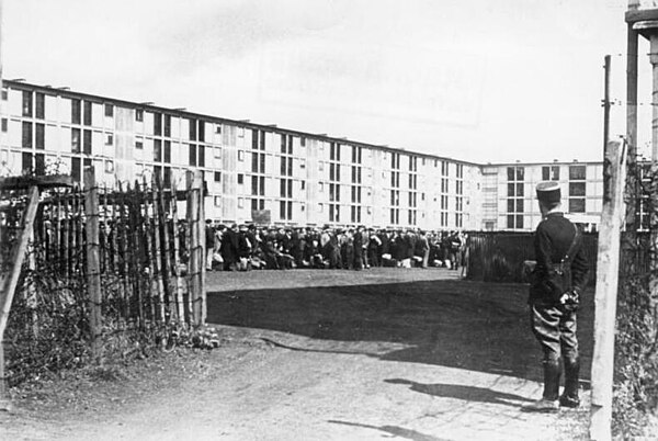 A French gendarme guarding Jews held at the Drancy internment camp