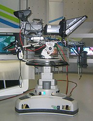TV camera with lens and a teleprompter on a pedestal Camaras Sony 1 (cropped).JPG