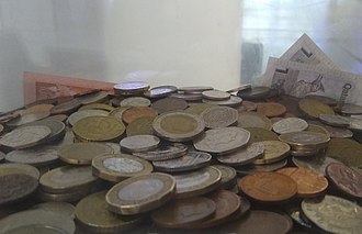 Donations of spare change in various currencies at Heathrow Airport Coin donations.jpg