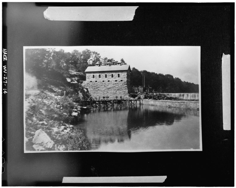 File:Credit PED. Downstream elevation, near completion, showing tail race and trestle used to carry excavated rock and construction materials across tail race. Photo c. 1909. - Dam HAER WVA,2-SHEP.V,1-14.tif
