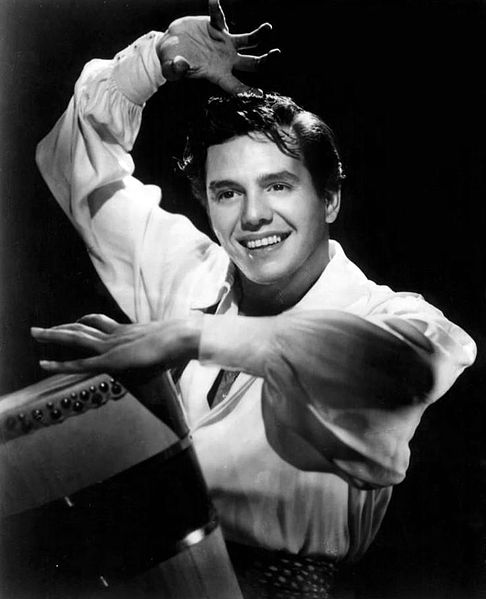 Desi Arnaz playing a bokú in the 1940s. His father had banned the bongos 20 years earlier. The bokú is the most likely ancestor of the bongos.