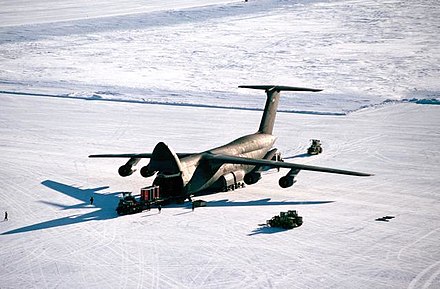 Personnel unload cargo from a C-5 Galaxy at Pegasus Field, an ice runway near McMurdo Station, Antarctica, in 1989
