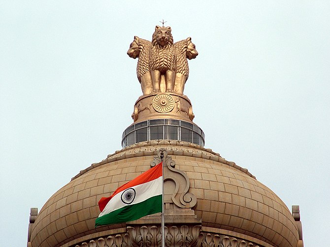 Indian flag and the State Emblem atop Vidhana ...