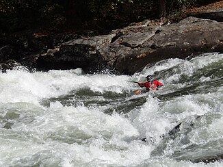 A kayaker drives the Iron Ring Rapids