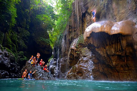 A man attempted to jump from the famous mushroom-shaped rock in Green Canyon Indonesia Jumping Rock.jpg