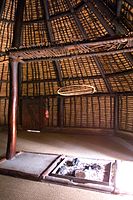 Inner view of a Kanak hut with a hearth