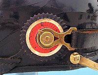 A metal cockade on the swivel of a Pickelhaube helmet. Kokarde Schwarz-Weiss-Rot 1897.jpg