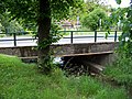 Čeština: Říčany-Kuří, okres Praha-východ. Most Rooseveltovy ulice přes Pitkovický potok. English: Říčany-Kuří, Prague-East District, Central Bohemian Region, Czech Republic. A bridge of Rooseveltova street over the Pitkovice Creek. Camera location 49° 59′ 15.1″ N, 14° 37′ 12.3″ E    View all coordinates using: OpenStreetMap